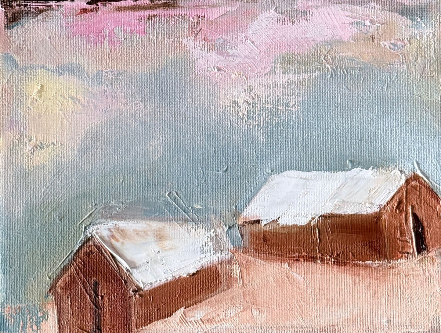 Original oil painting of two rust brown barns with snowy white roofs under a pink sky from the Home series by Tamar Green