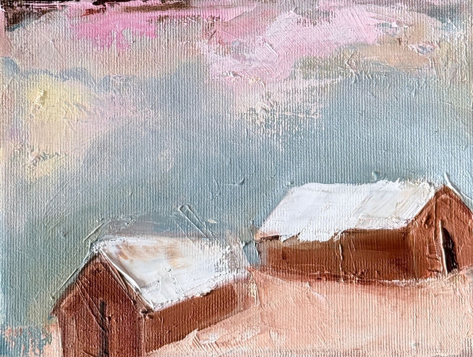 Original oil painting of two rust brown barns with snowy white roofs under a pink sky from the Home series by Tamar Green
