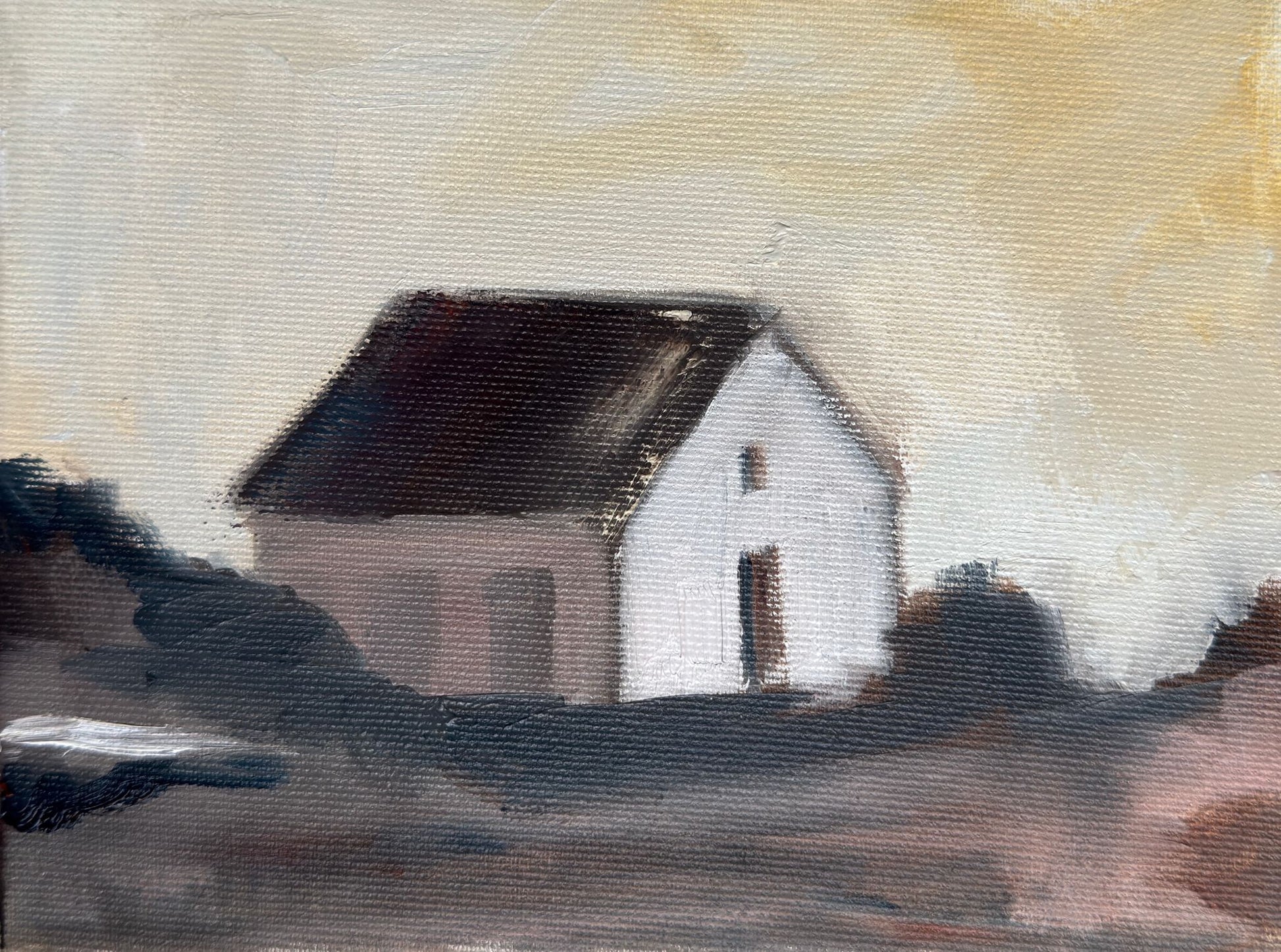 Original oil painting of a small white cottage flanked by dark trees against a golden evening sky, from the Home series by Israeli artist Tamar Green