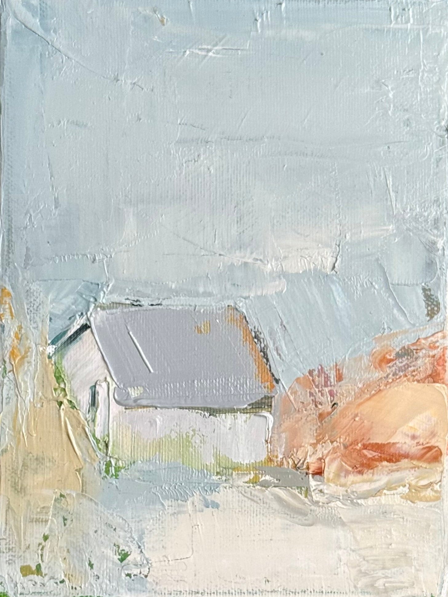 Original oil painting of a small house with grey roof in soft pale blue and peach landscape with misty atmosphere, from the Home series by Israeli artist Tamar Green